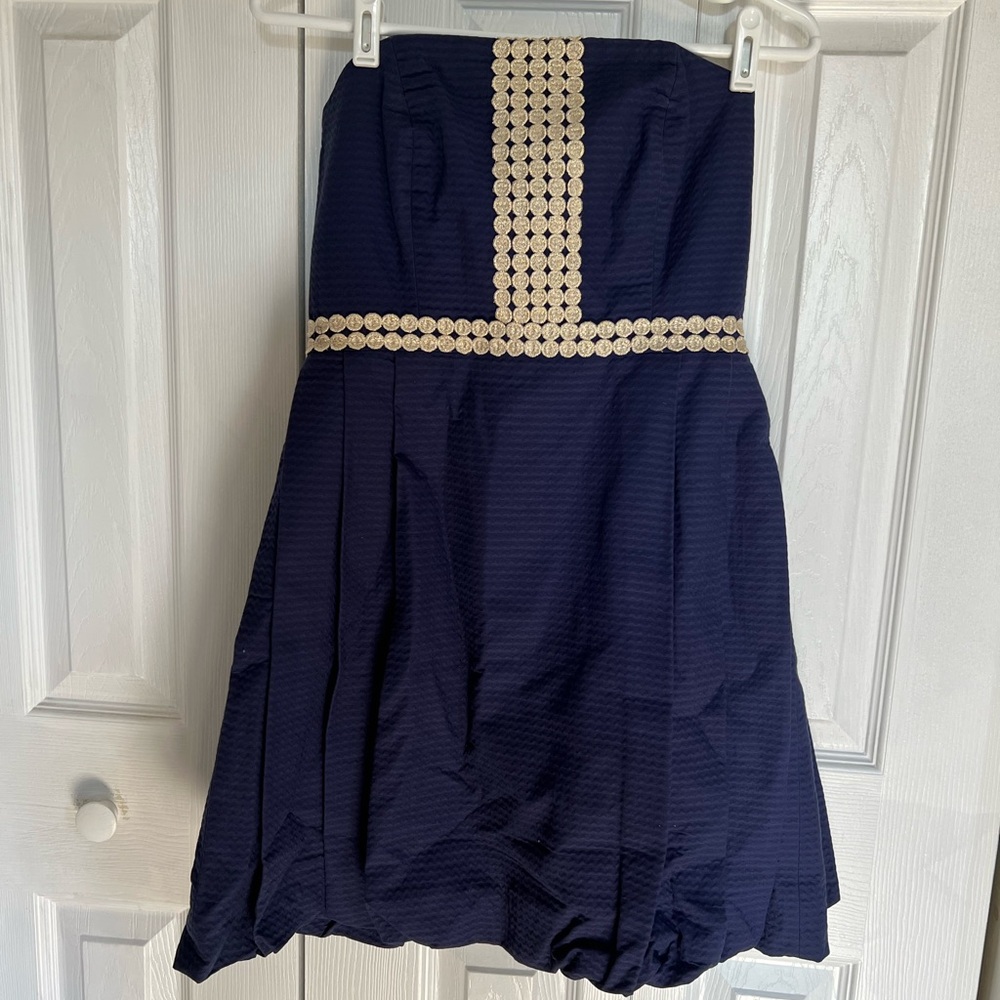 Beautiful navy blue strapless dress with gold embellishments. Size 4.